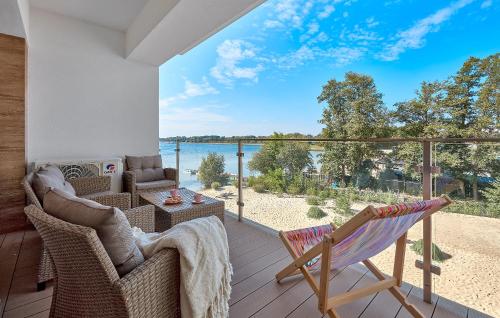 a porch with chairs and a view of the water at Boszkowo Horizon Park Apartament 27 "Romantic" in Boszkowo