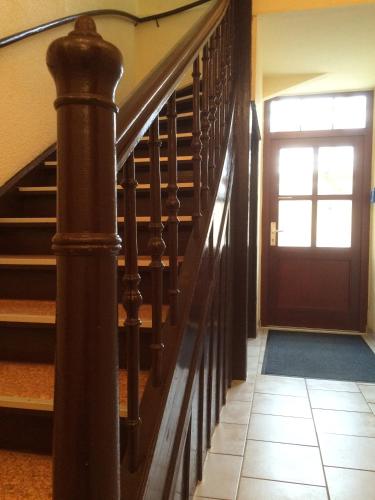 a hallway with a staircase with a door and a door at Alte Druckerei in Quedlinburg