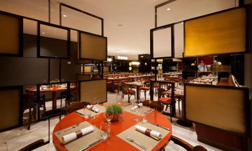 a dining room with tables and chairs in a restaurant at Altis Grand Hotel in Lisbon