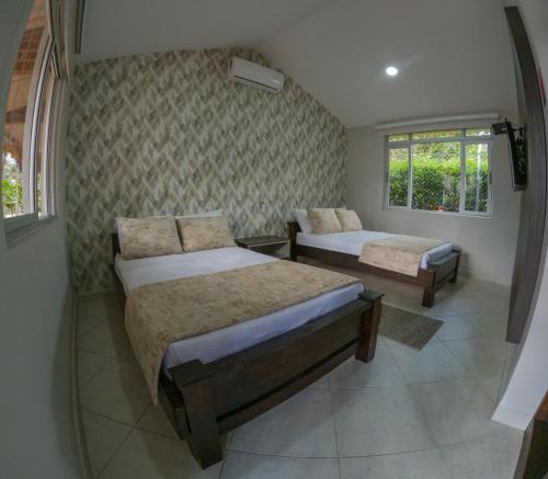 Ένα ή περισσότερα κρεβάτια σε δωμάτιο στο Hotel Campestre Palma Verde