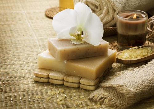a pile of soap and a white flower on top at Grand Regal Hotel in Doha