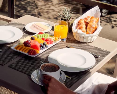 a table with a tray of food and a cup of coffee at Altis Grand Hotel in Lisbon