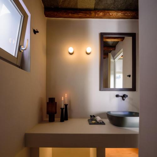 a bathroom with a sink and a mirror at Seascape Suites Folegandros in Ano Meria