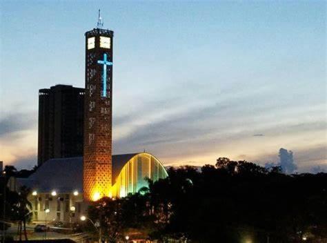 a tall clock tower in front of a building at Apartamento Laranja Matão in Matão