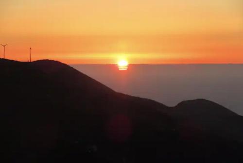 a sunset over a mountain with the sun on the horizon at Authentic country house Casa Gloria with fantastic views in Franceses
