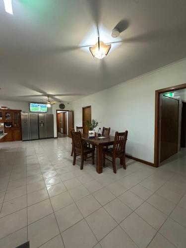 a dining room with a table and chairs and a ceiling fan at Guest Room in Kealba in St Albans