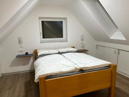 a bedroom with a bed with a tv on the wall at Ferienhaus im Rundling in Clenze