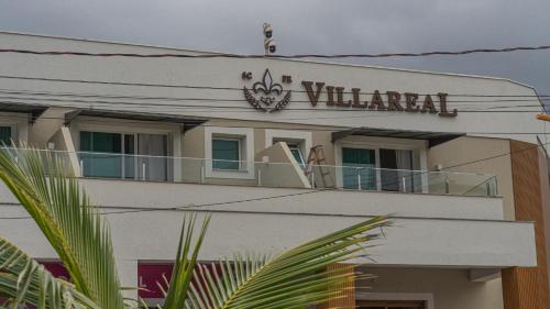 a building with a sign on top of it at Hotel VillaReal Charme in Guaratuba