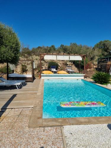 a swimming pool in a yard with at Casa Maichen Olbia in San Pantaleo