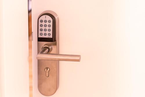 a bathroom door with a faucet with a remote control at Brauhaus-Hotel König von Flandern in Augsburg
