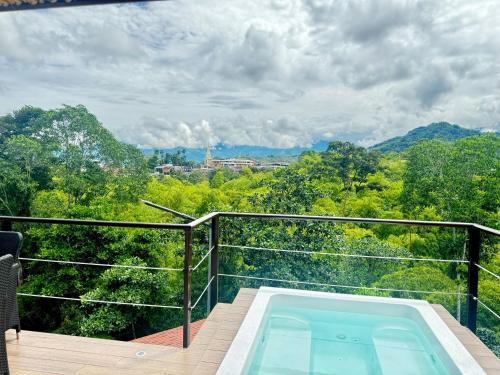 a balcony with a swimming pool and a view of trees at Pachakuti Eco-vida Hotel in Caicedonia