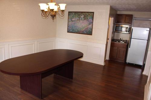 a kitchen with a table and a refrigerator at Bluegrass Extended Stay in Lexington