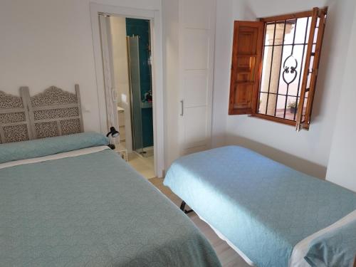 En eller flere senge i et værelse på Apartamento Armiñán Ronda- parking opcional