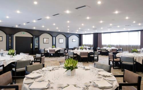 a dining room with tables and chairs and tablesktop at Altis Grand Hotel in Lisbon