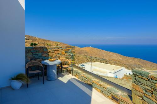 a balcony with a table and chairs and the ocean at Seascape Suites Folegandros in Ano Meria