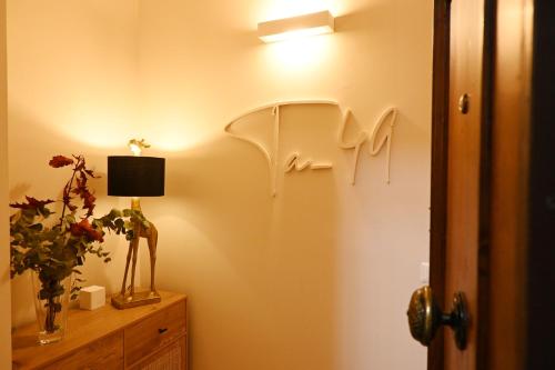 a room with a light on a wall with a lamp at Ta-49 bed e breakfast in Naples