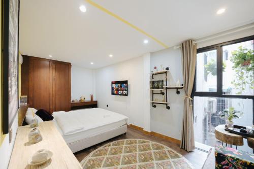 a bedroom with a bed and a large window at Rik Homestay in Hanoi
