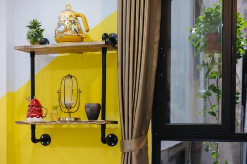 a room with yellow walls and shelves at Rik Homestay in Hanoi