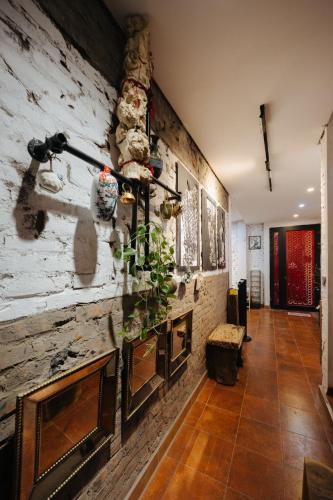 a living room with a stone wall with a counter at Rik Homestay in Hanoi