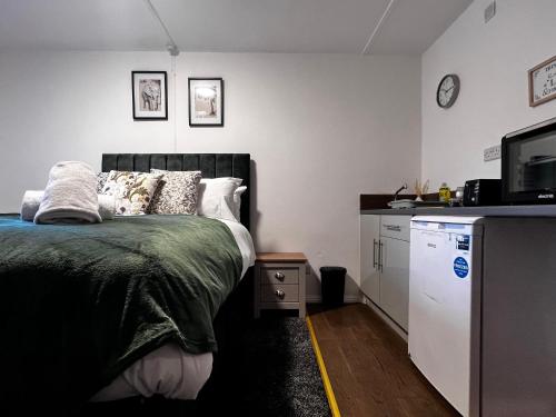 a bedroom with a bed and a tv and a counter at BV Aparthotel Castleford Perfect for Cooperate and Leisure Stays in Castleford
