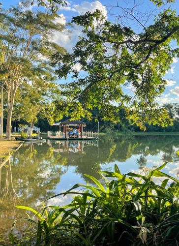 a view of a lake with a dock at Fazenda JB in Sete Lagoas