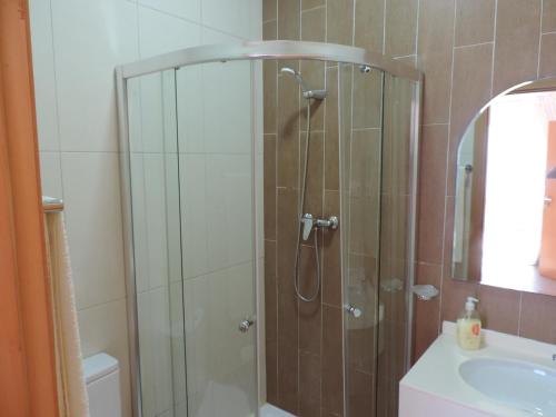 a shower with a glass door in a bathroom at Hotel Halcyone - Ilha do Maio in Calheta Do Maio