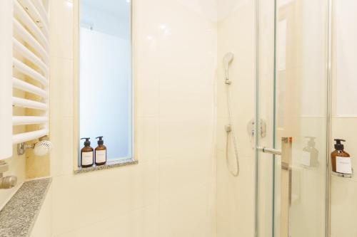 a bathroom with a shower and a mirror at Apartment mit Traveblick in Lübeck