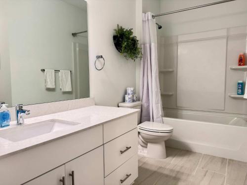 a white bathroom with a sink and a toilet at Luxury New 1B1B Private Balcony w Dryer Washer 525Pkwy211 in Atlanta