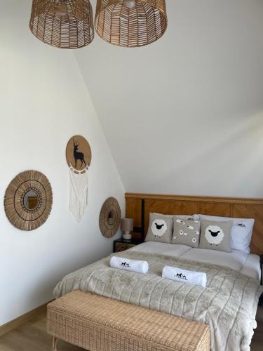 a bedroom with a bed with pillows on it at Ciwersówka Domki Białka Tatrzańska in Białka Tatrzanska