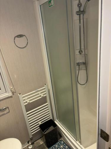 a bathroom with a shower with a glass door at The Lay By in Prestonpans