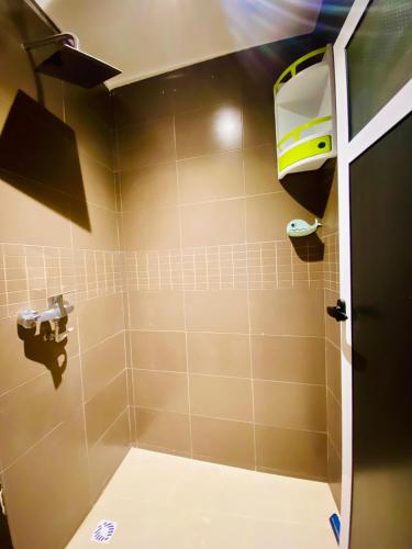 a bathroom with a shower with a toilet at SurfsHub Hostel Taghazout in Taghazout