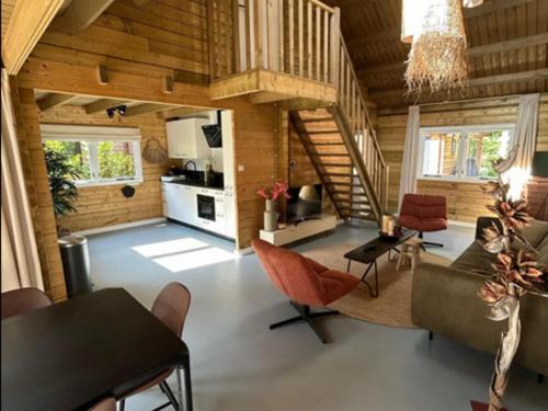 a large living room with a table and chairs at Oak Valley 15 in Ons Belang