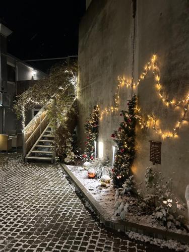 a courtyard with christmas trees and lights on a wall at Hotelgasthof Kirchenwirt in Schierling