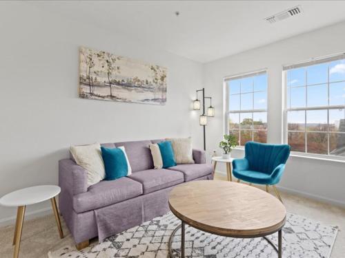 a living room with a couch and a table at Tysons Galleria Retreat in Tysons Corner