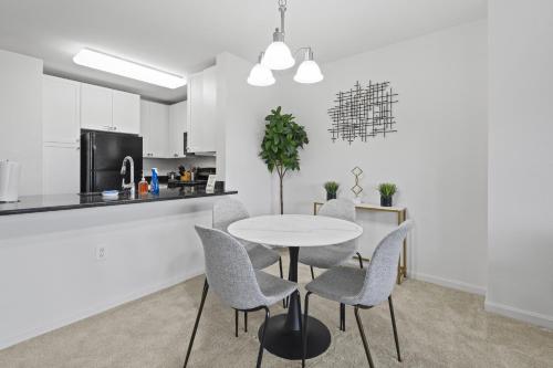 a kitchen and dining room with a table and chairs at Tysons Galleria Retreat in Tysons Corner