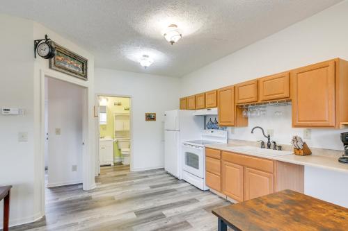a kitchen with white appliances and wooden cabinets at Apt with Lake Views - Day Trip to Virginia Tech! in Radford