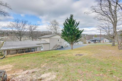 a house with a tree in the middle of a yard at Apt with Lake Views - Day Trip to Virginia Tech! in Radford