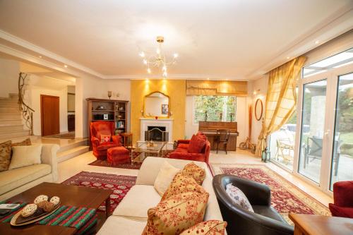 a living room with a couch and chairs at 2K Eco Villa in Plagiárion