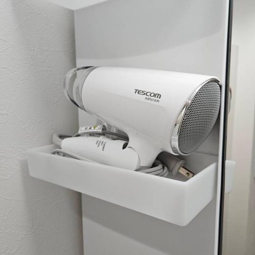 a white appliance sitting on a shelf in a room at Onasyas-A in Hakodate