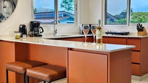 a kitchen with a counter with two glasses of wine at El Cielo by Villa Alejandro in Boquete