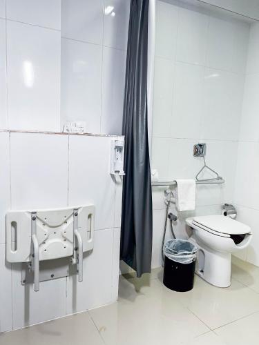 a white bathroom with a toilet and a sink at Royal Design Savassi Hotel in Belo Horizonte