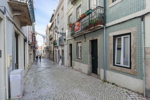 an empty alley with people walking down the street at Madragoa Studio Zero in Lisbon