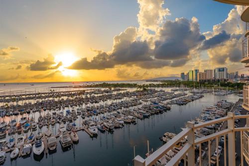 a group of boats docked in a marina at sunset at Oceanfront Renovated Getaway in Waikiki in Honolulu