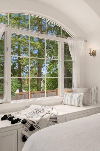 a white bedroom with a window and a bed at DT Bellevue Hidden Gem With a View & AC in Bellevue