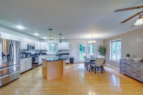 a large kitchen with white cabinets and a dining table at Linden Family Home with Yard Less Than 5 Mi to Wineries! in Front Royal