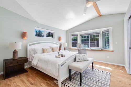 a bedroom with a white bed and a chair at Mid-Century Modern Home - 3-Bedroom Rambler in Kirkland