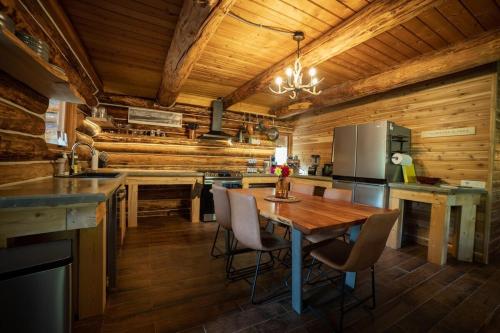 a kitchen with wooden walls and a wooden table and chairs at The Airstrip in Talkeetna