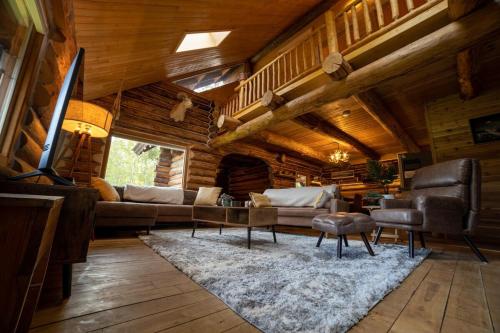 a living room with a couch and a table at The Airstrip in Talkeetna