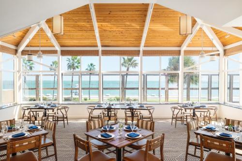 a large room with tables and chairs and windows at Omni Corpus Christi Hotel in Corpus Christi