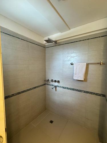 a bathroom with a shower with a white towel at Terrazas RV Adults Only No se cobran los impuestos in Posadas